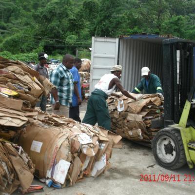 Cardboard bails being loaded into a container
