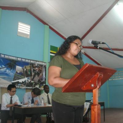 A woman standing at a podium giving a speech