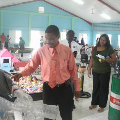 Petter St. Jean viewing recycled items made by the students