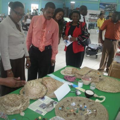 People looking at the items made of straw
