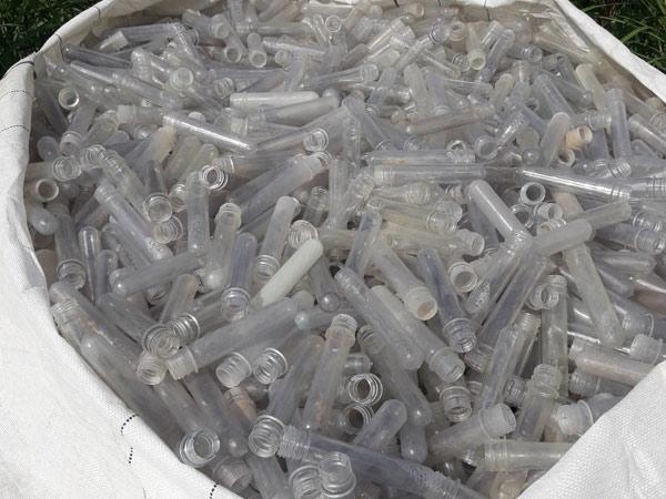 A big white bag of plastic test tubles ready for recycling