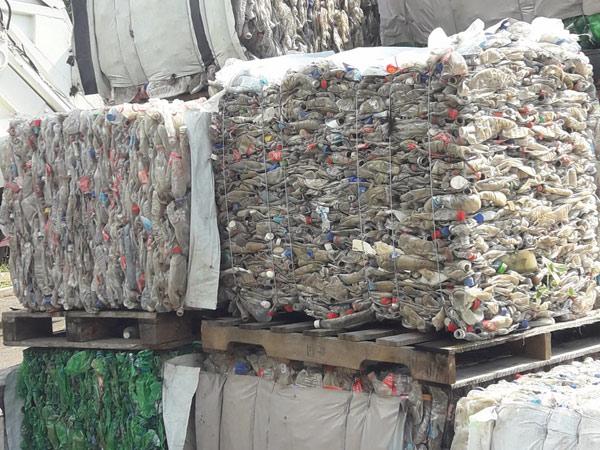 Bails of compressed plastic bottles ready for recycling
