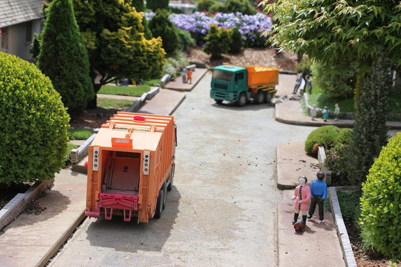 Workers standing on the garbage truck